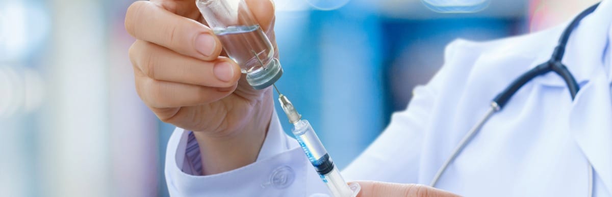 4 Common Types of Back Pain Explained-5 A doctor withdraws the plunger on an injection needle used to treat types of back pain