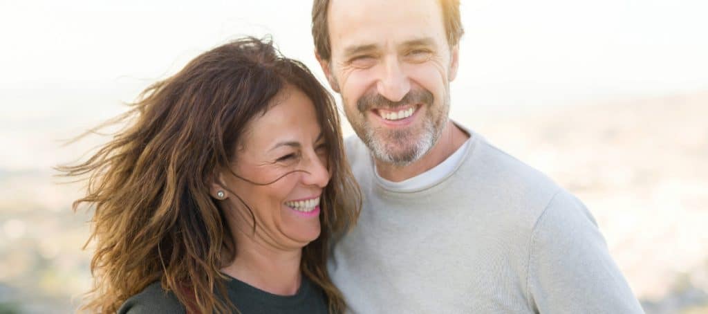 A couple smiles together after platelet rich plasma facial treatment