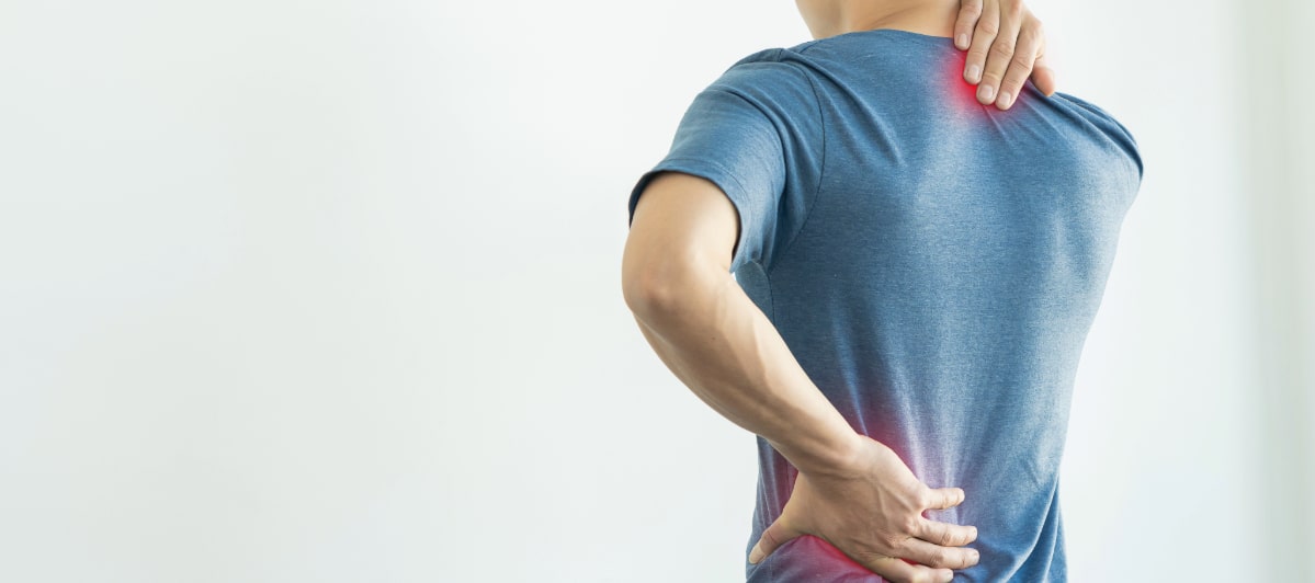 5 Conditions Treated by Peripheral Nerve Stimulation-4-Pain A man grabs his back due to chronic pain