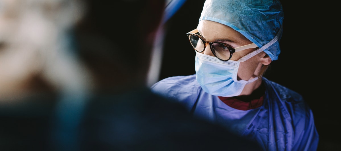 5 Conditions Treated by Peripheral Nerve Stimulation-6-Doctor A doctor wearing an exam mask performs peripheral nerve stimulation