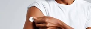 A man takes off a diabetes patch on his arm