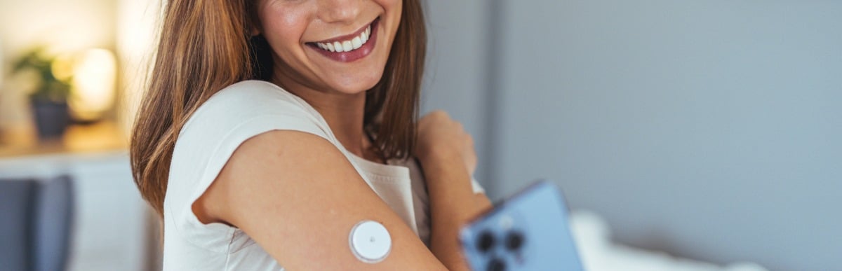 5 Facts You Didn't Know About the Diabetes Patch-4 A woman smiles as she checks her glucose levels via a diabetes patch