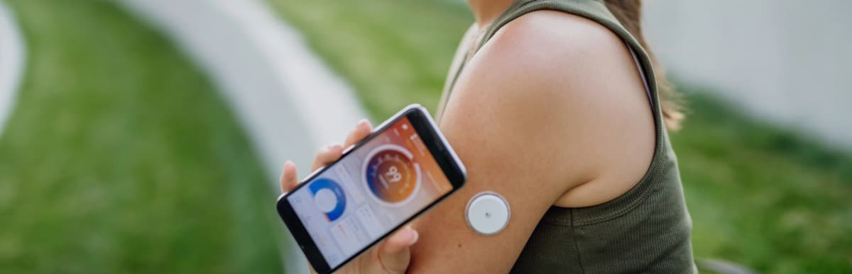 5 Facts You Didn't Know About the Diabetes Patch-5 A jogger checks her glucose levels with a diabetes patch and her phone