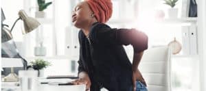 Person grabbing their back in pain