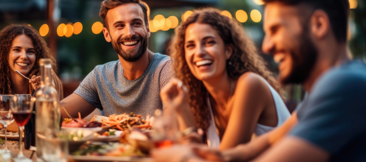 5 Reasons to Try Amino Acid Treatment-5-Radiant A group of people smile and laugh as they enjoy dinner