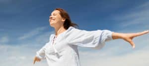 A person smiles and stretches out their hands