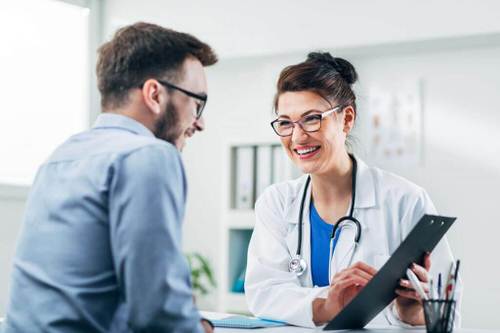 Female pain management doctor reviewing a form with a male patient