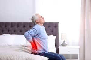 Senior man suffering from chronic back pain after sleeping on his back