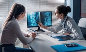 Doctor checking a patient's x-ray of spine
