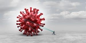 A man dragging a large covid virus to symbolize the long haul covid
