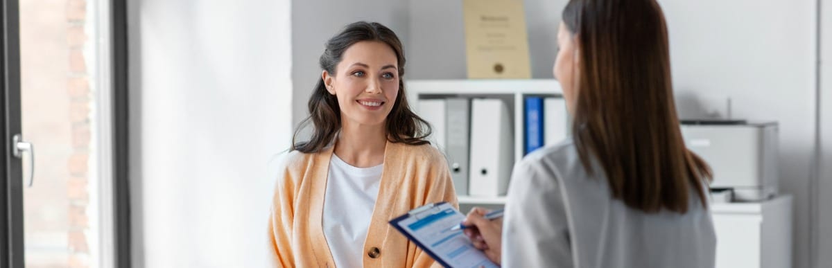 Can Electrical Stimulation Help Neuropathy in Feet-2-Patient A patient sits on an exam table and asks her doctor about peripheral nerve stimulation
