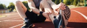 A runner sits and holds his food in pain before peripheral nerve stimulation