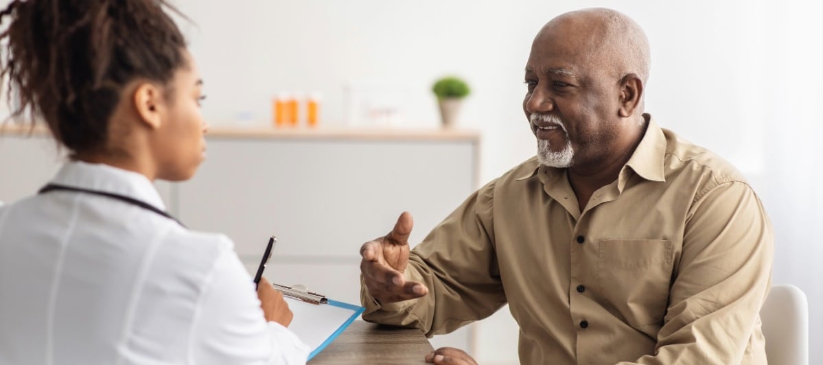 A patient speaks with his doctor about lumbar epidural injections for his lower back pain