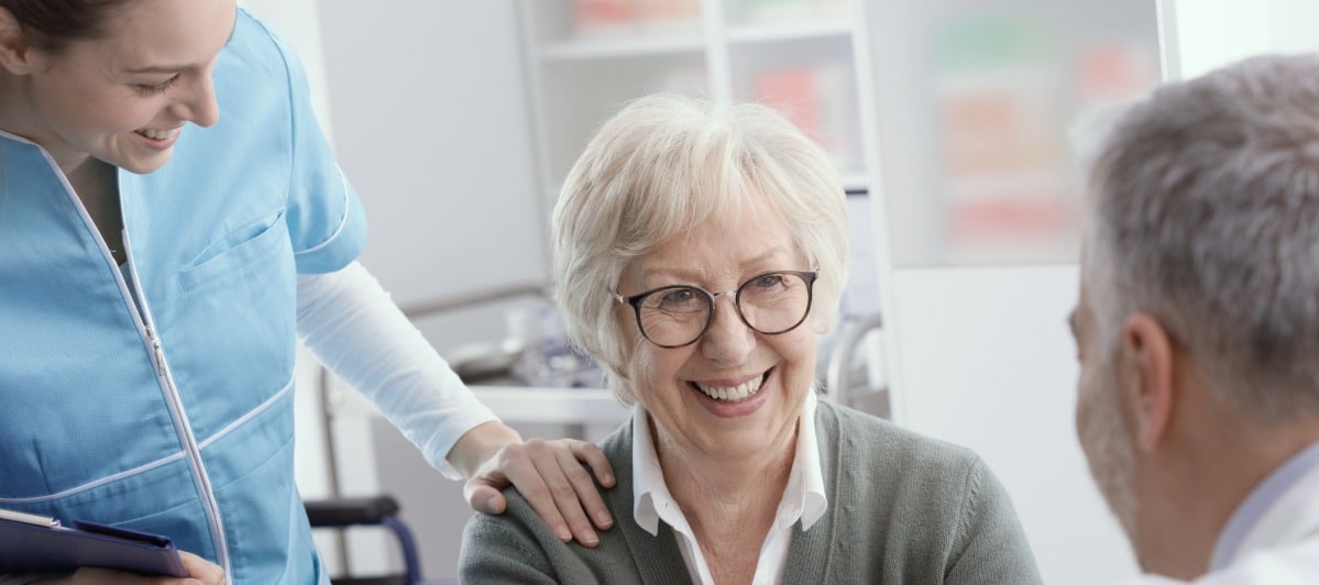 Can Epidural Injections Help Your Lower Back Pain-5-Recovery A patient smiles as a nurse and doctor monitor her recovery after an lumbar epidural injection