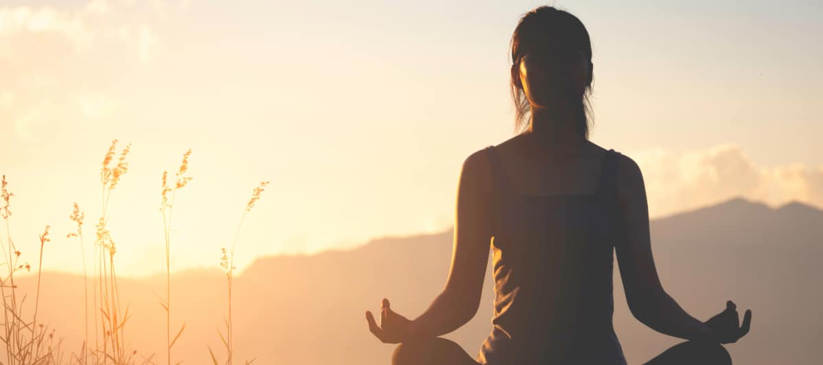 Can Weight Loss Injections Reduce Chronic Pain-5-Yoga A woman meditates on a mountaintop during a sunrise