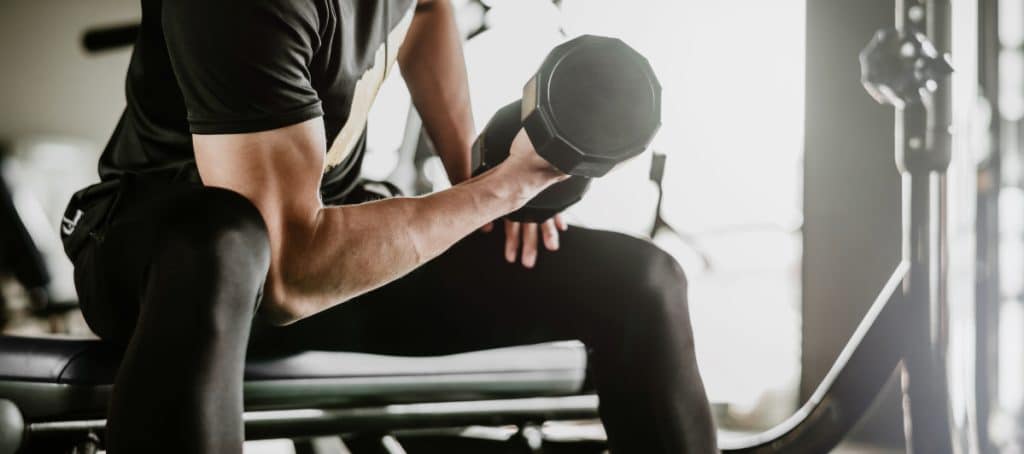 A man performs a curl with a dumbbell