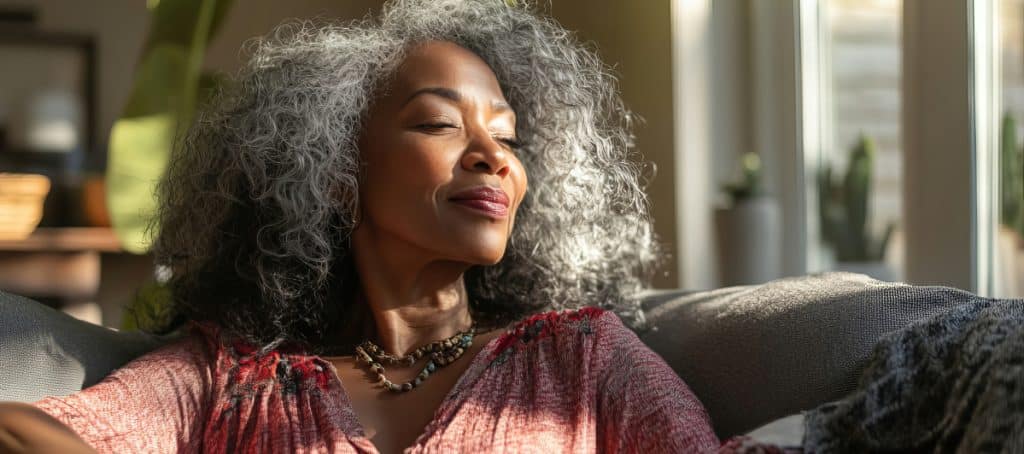 A woman closes her eyes and smiles