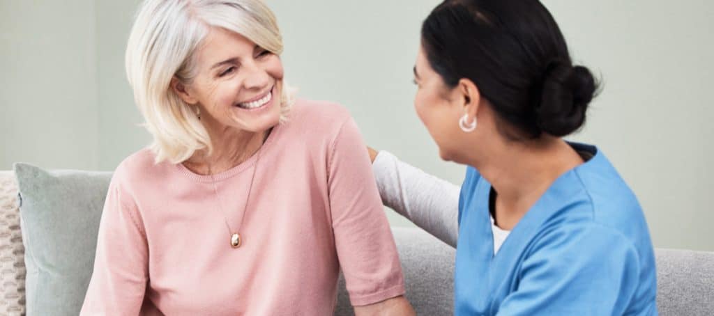 A patient smiles at her doctor during an appointment for diabetic peripheral neuropathy treatment