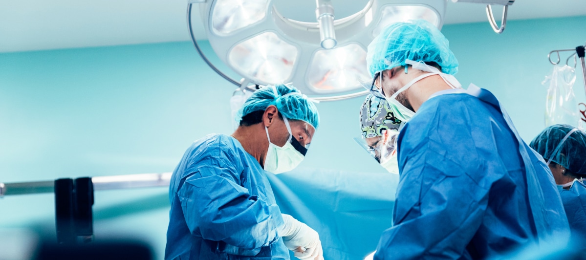 Effective Pain Relief Strategies for Spinal Stenosis-6-Back in Surgeons in an operating room performing injections to eas the pain of spinal stenosis