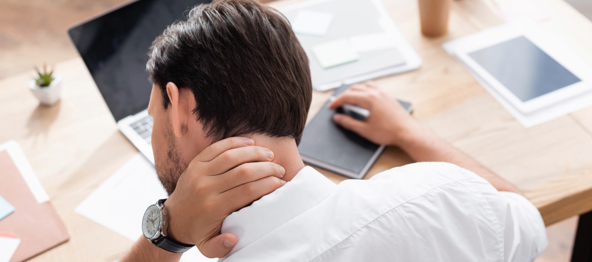 Exploring Minimally Invasive Treatments for Injuries-4-Neck Pain A man grabs his neck in pain due to an injury