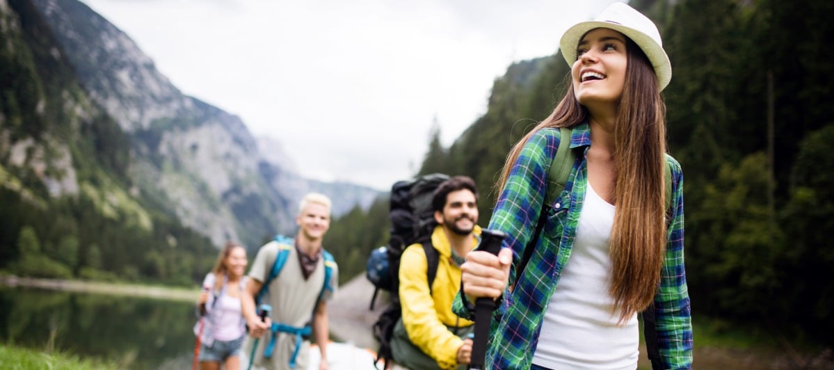 Exploring Neurostimulation Devices and Treatments-3-Hikers A group of people smile as they hike through a forest