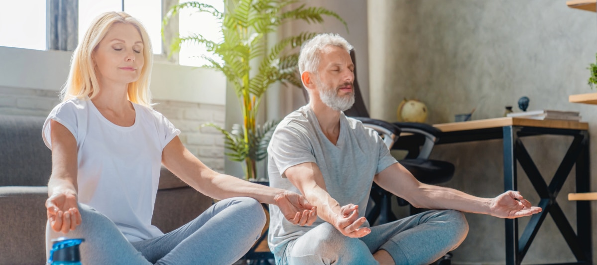 FAQs About Sacroiliac Joint Treatments for Hip Pain-5-Yoga An older couple sits on the floor and meditates after hip fusion treatment