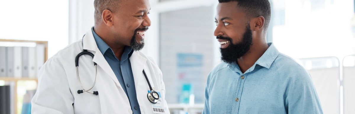 Four Benefits of a Diabetes Management Plan-4 A doctor in a lab coat smiles as he discusses a diabetes management plan with a patient