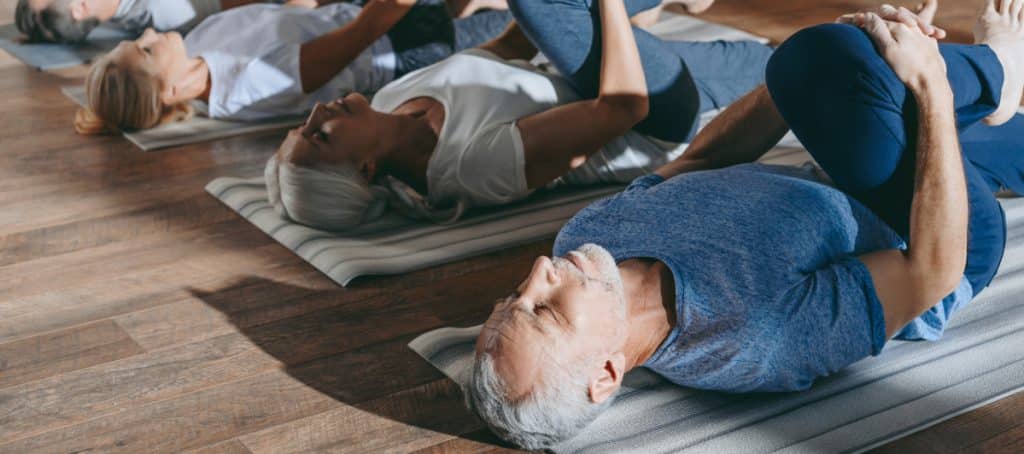 A class of older people practice yoga to enhance diabetic neuropathy reversal