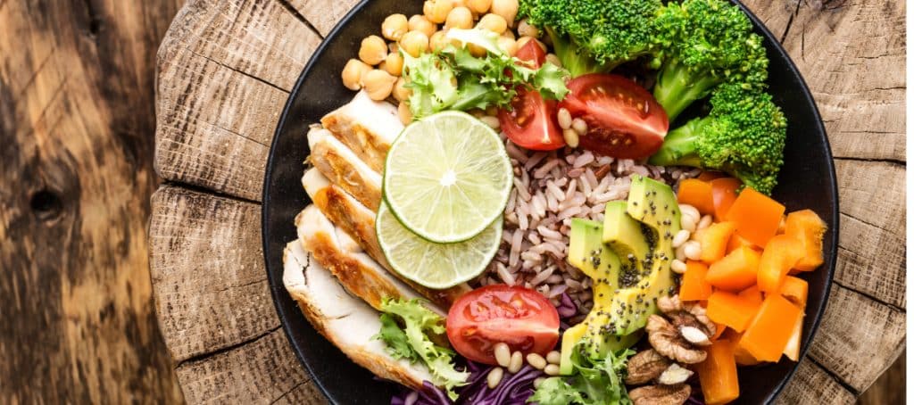 A plate with nutritious food such as rice, vegetables, and grilled chicken