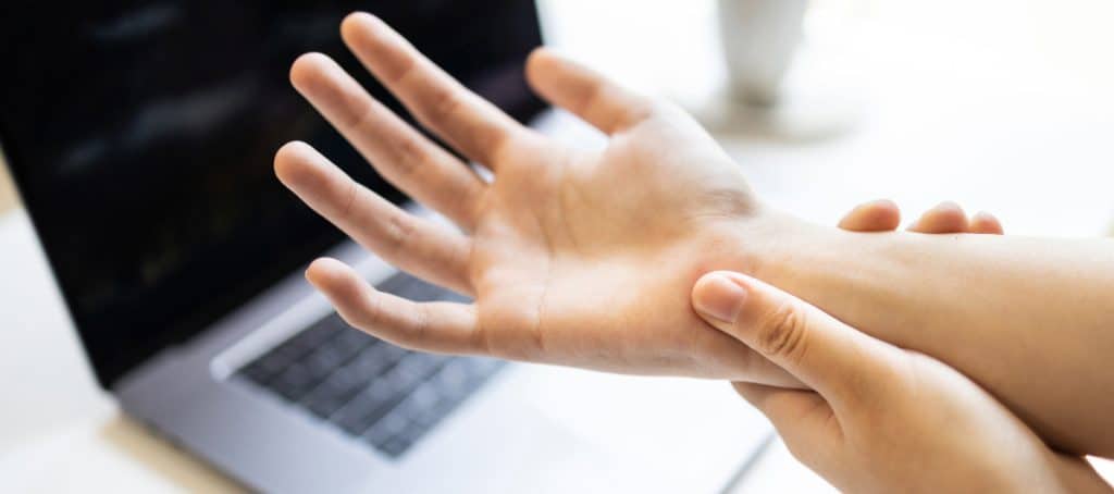 A person rubs their hands due to diabetic neuropathy pain