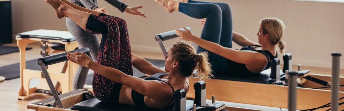Heart Disease Symptoms You Need to Know (20) Two women participate in a Pilates class to ease upper middle back pain