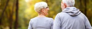 An older couple enjoys a nature walk after enhanced energy with regenerative medicine treatments
