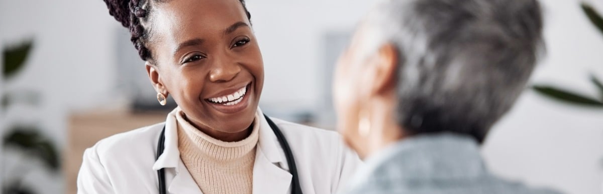 Heart Disease Symptoms You Need to Know - 2026-06-25T102902.128 A doctor in a lab coat talks to her patient about the connection between hormones and pain