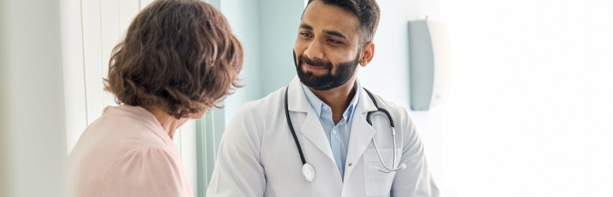 Heart Disease Symptoms You Need to Know - 2026-07-07T100041.456 A doctor in a lab coat listens to to a patient ask about functional rehabilitation