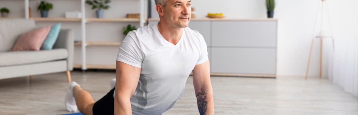 Heart Disease Symptoms You Need to Know - 2026-07-08T094710.748 A man stretches his back by holding a yoga pose after The Intracept Procedure