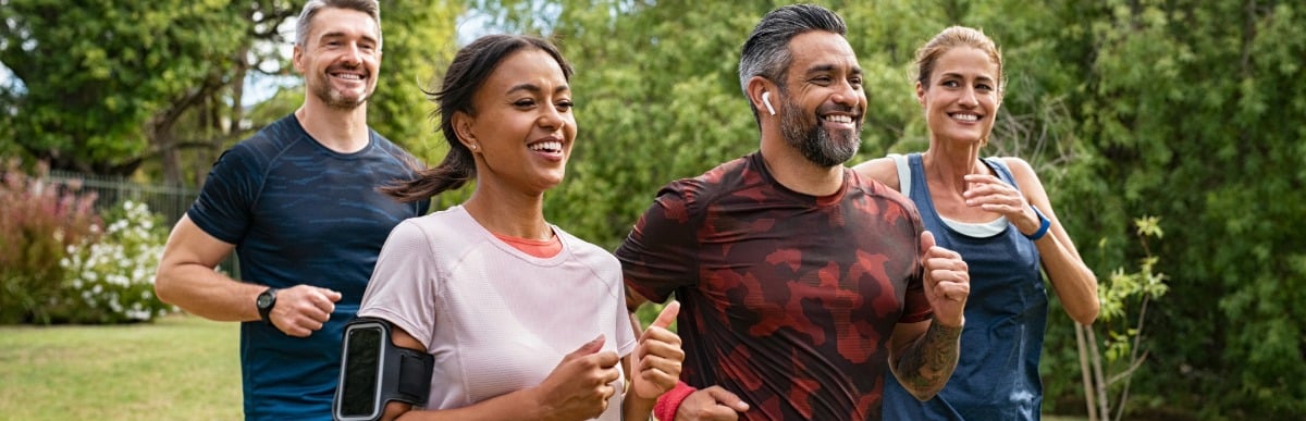 Heart Disease Symptoms You Need to Know (30) A group of friends smile as they jog through a park after treatment for upper back pain