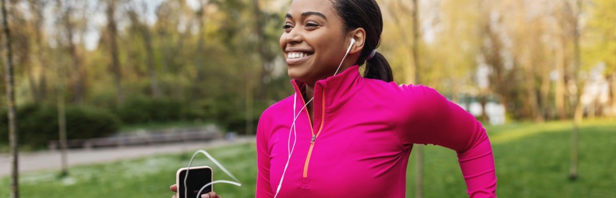 Heart Disease Symptoms You Need to Know (37) A woman smiles as she jogs through a park after improved movement from epidural pain management