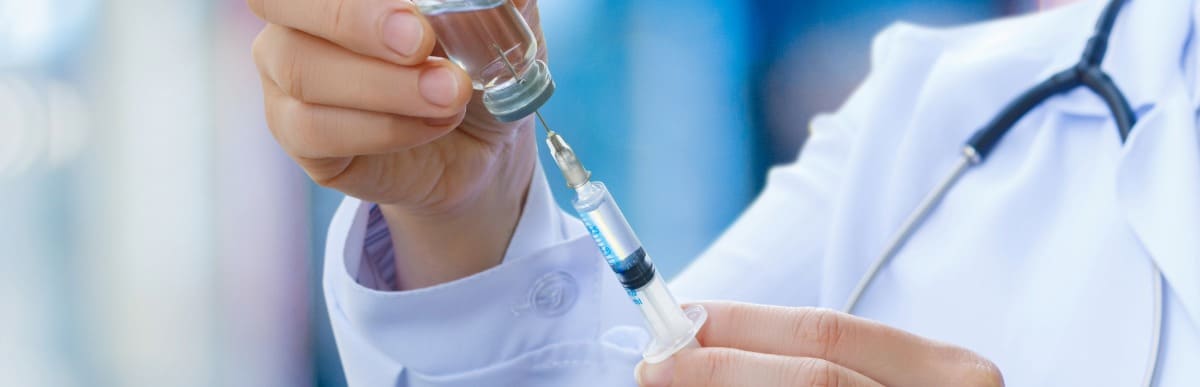 Heart Disease Symptoms You Need to Know (39) A doctor prepares an injection needle as part of a patient's epidural pain management