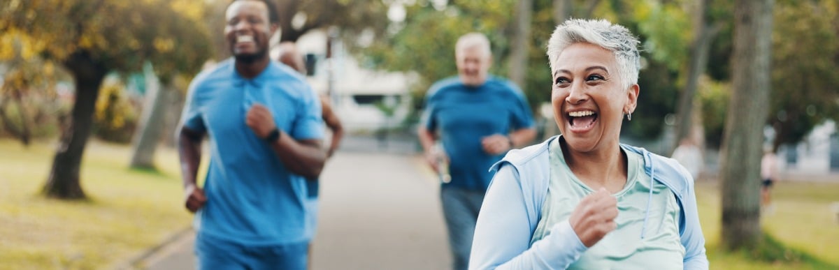 Heart Disease Symptoms You Need to Know (43) A woman laughs as she jogs with her friends in a park to ease early signs of automimmune arthritis