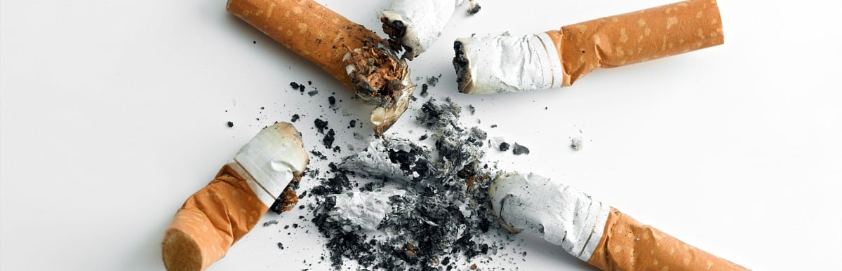 Heart Disease Symptoms You Need to Know-5 Several cigarettes and ash are on a surface, indicating heart disease symptoms often result from smoking