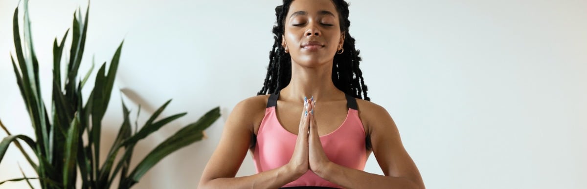 Heart Disease Symptoms You Need to Know (60) A woman smiles as she meditates after receiving neurostimulation device treatment