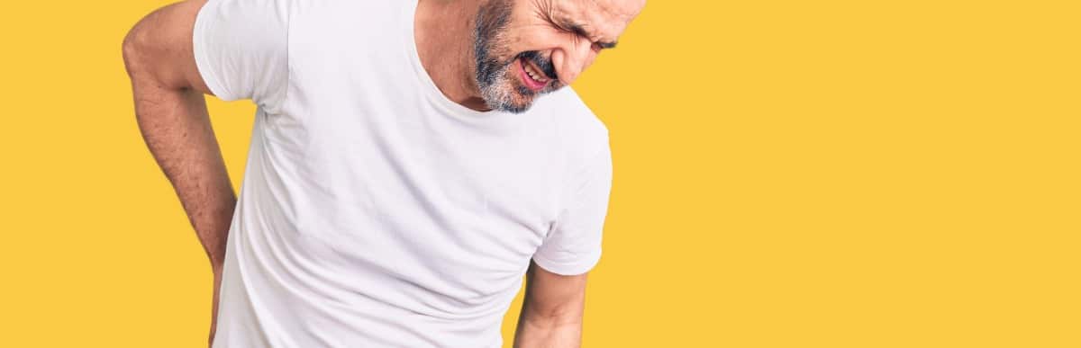 Heart Disease Symptoms You Need to Know (63) A man in need of epidural steroid injections winces and holds his back in pain