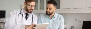 A doctor in a lab coat talks to a patient about the latest neurostimulation devices