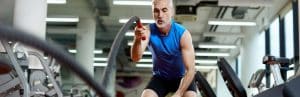 A man uses heavy ropes to exercise at a gym after peptide therapy for muscle recovery