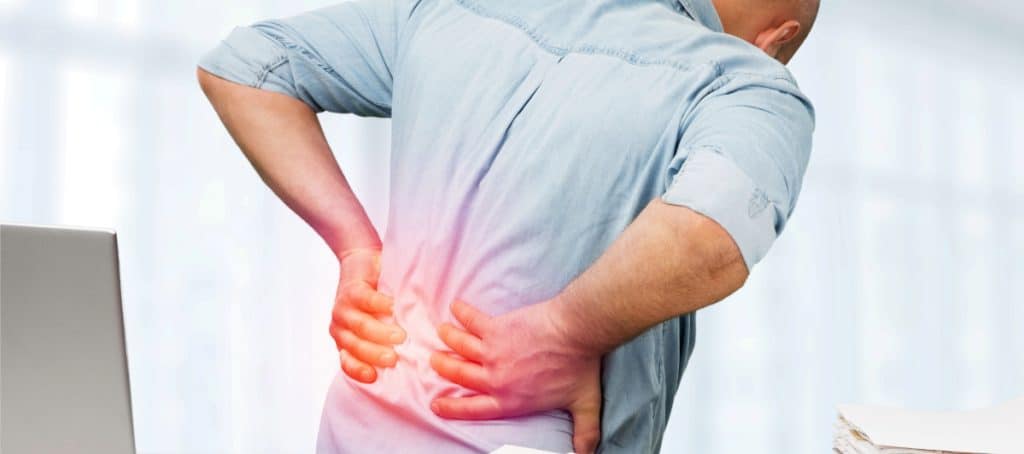 Person grabbing their back in pain