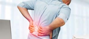 Person grabbing their back in pain