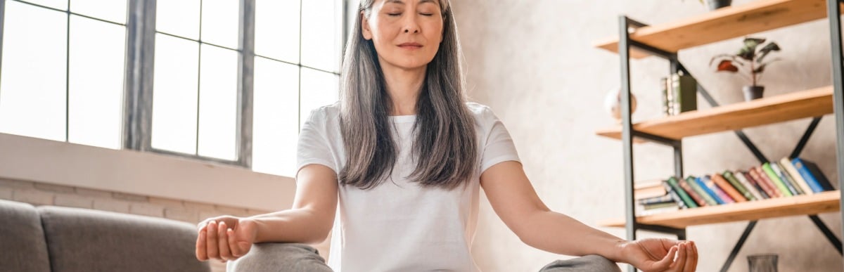 How Diabetes Management Programs Revolutionize Care-3 A woman sits cross-legged and meditates as part of her diabetes management programs
