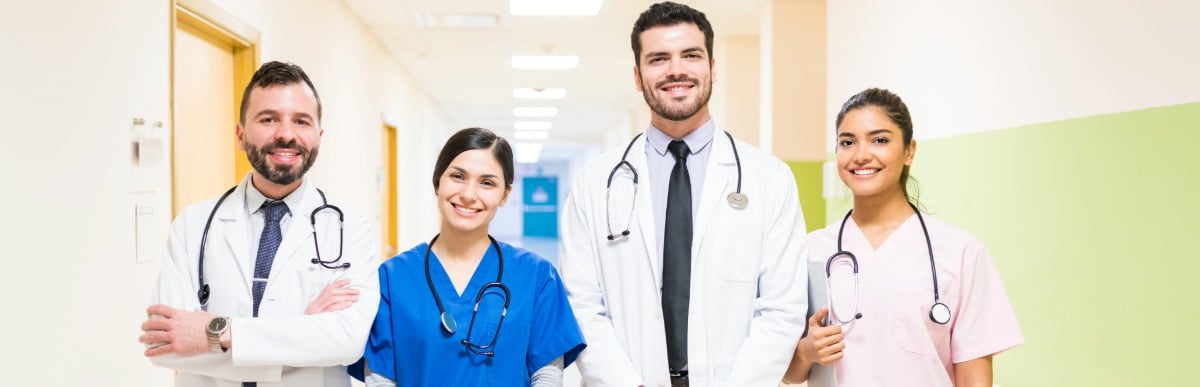 How Diabetes Management Programs Revolutionize Care-4 A diabetes management programs team of doctors and nurses smile while standing in a hospital hallway