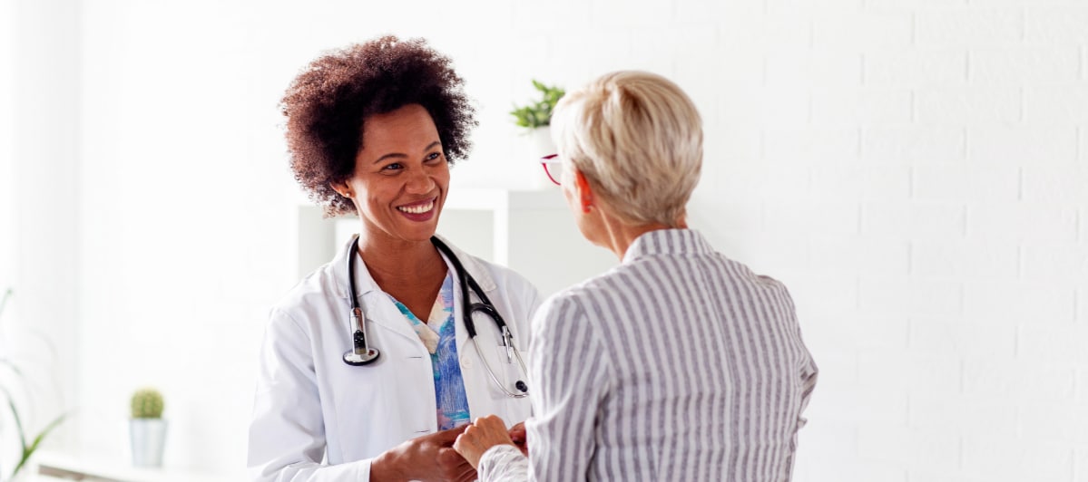 A doctor smiles as she speaks with her patient about diabetic neuropathy