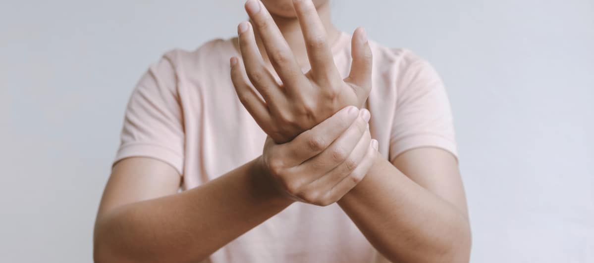 How Does Peripheral Nerve Stimulation Work-6-Hands A woman rubs her hands due to tingling from neuropathic pain